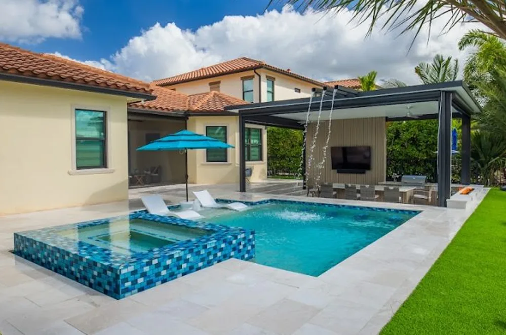 Custom pool with spa and blue glass tile