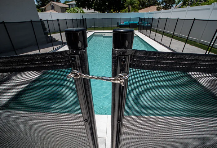 Backyard pool with mesh safety fence