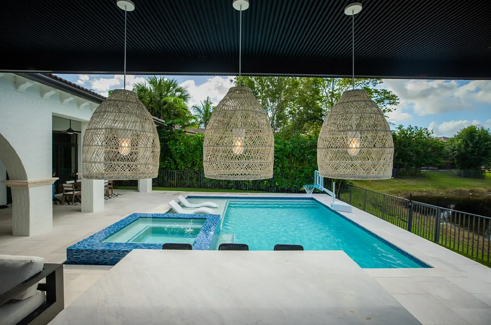 Pool and spa next to a covered outdoor lounge